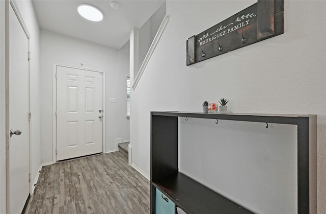 corridor with hardwood / wood-style flooring