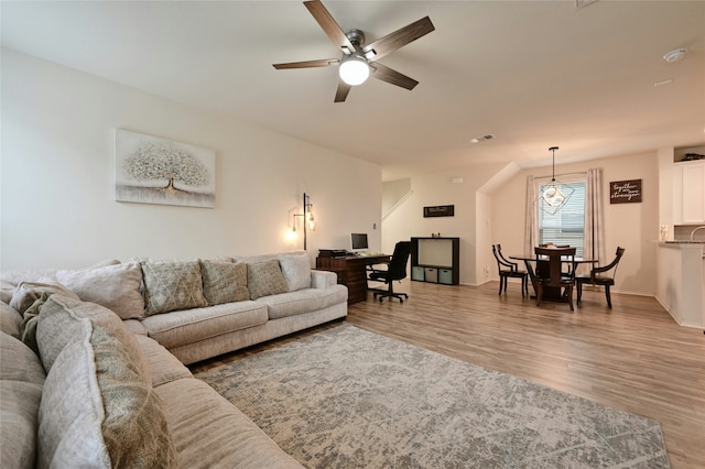 living room with ceiling fan and light hardwood / wood-style flooring