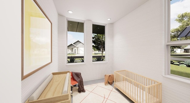 tiled bedroom with a nursery area and multiple windows