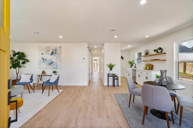 6811 Montana St, Austin, TX 78741 - dining room with light wood-type flooring, recessed lighting, and baseboards