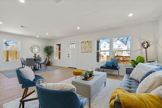 6811 Montana St, Austin, TX 78741 - living room featuring plenty of natural light, light wood-style flooring, recessed lighting, and baseboards