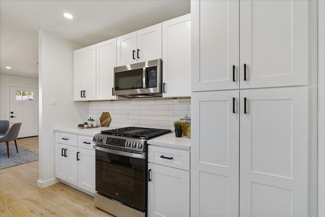 6811 Montana St, Austin, TX 78741 - kitchen with appliances with stainless steel finishes, light wood finished floors, light countertops, recessed lighting, and backsplash