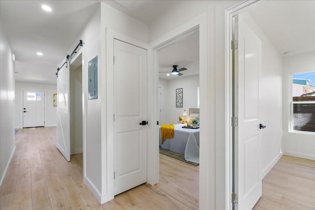 6811 Montana St, Austin, TX 78741 - corridor with a barn door, light wood-style flooring, electric panel, healthy amount of natural light, and recessed lighting