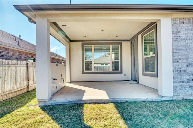 entrance to property featuring a patio