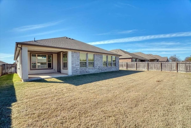 rear view of property with a patio area and a lawn