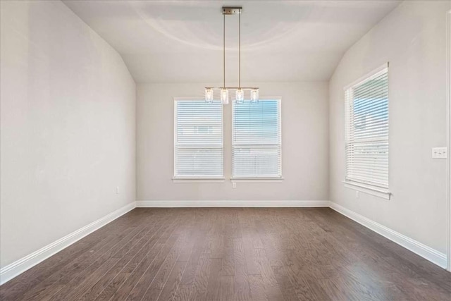 empty room featuring lofted ceiling and dark hardwood / wood-style flooring