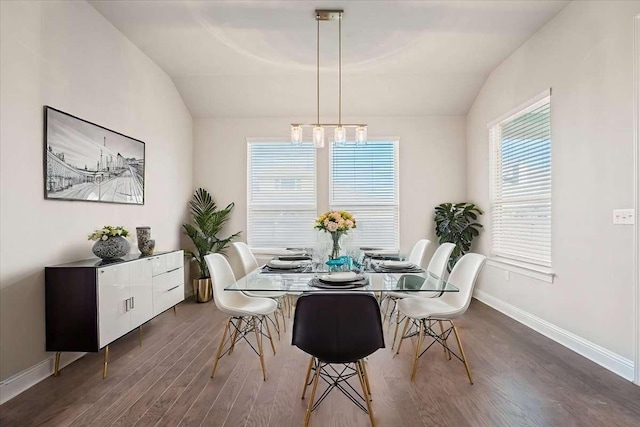 dining room featuring dark hardwood / wood-style floors and vaulted ceiling