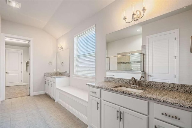 bathroom with a shower with shower door, vanity, and lofted ceiling