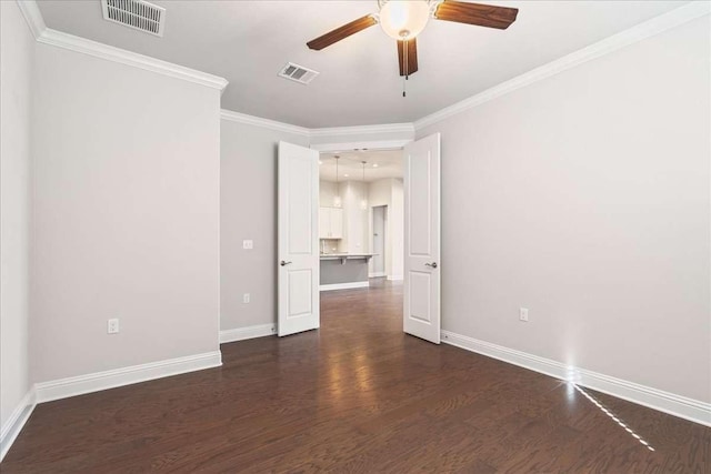 spare room with ceiling fan, ornamental molding, and dark hardwood / wood-style floors