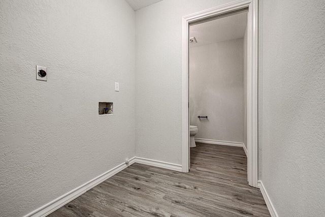 washroom featuring washer hookup, hardwood / wood-style flooring, and hookup for an electric dryer