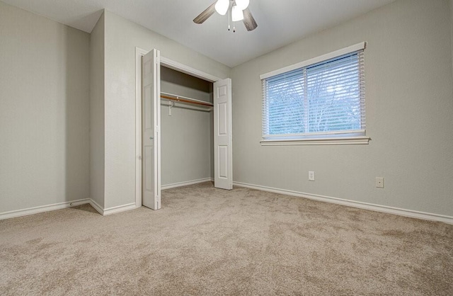 unfurnished bedroom featuring light carpet, a closet, and ceiling fan