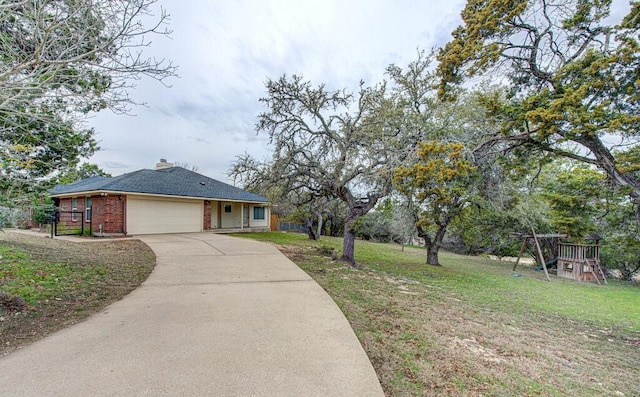 view of front facade featuring a garage, a playground, and a front lawn