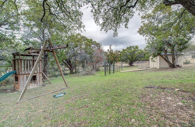 view of yard featuring a playground and a storage unit