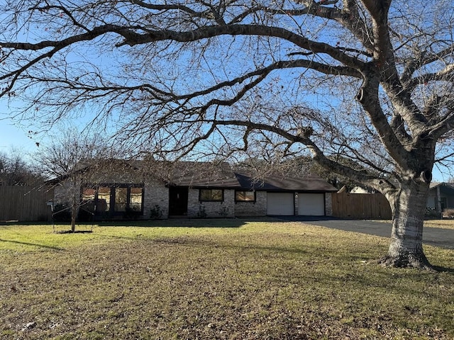 ranch-style house with a garage and a front yard