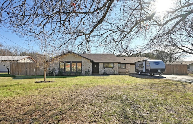 ranch-style home featuring a front yard