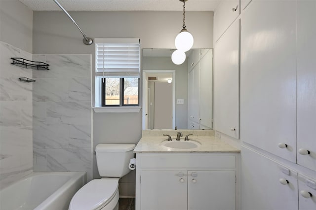 full bathroom with a textured ceiling, toilet, tiled shower / bath, and vanity