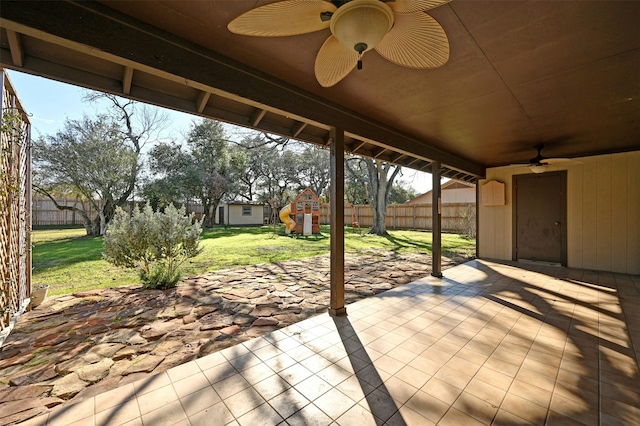 view of patio with a playground and ceiling fan