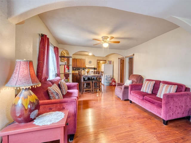 living room with ceiling fan and light hardwood / wood-style floors