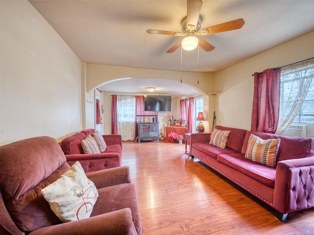 living room with hardwood / wood-style flooring, cooling unit, and ceiling fan