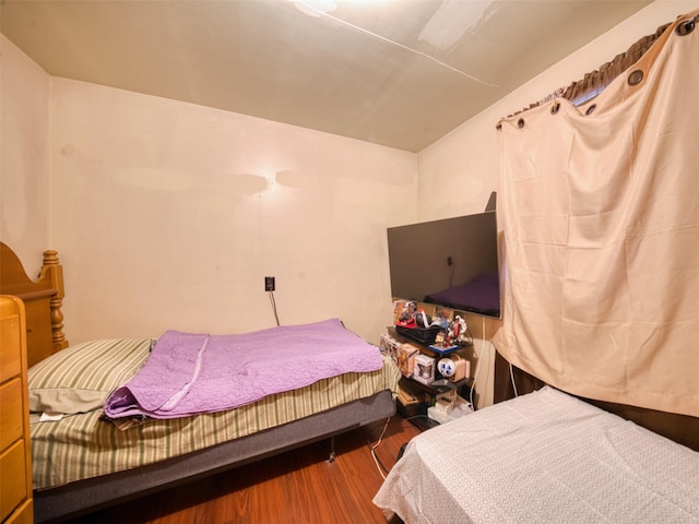 bedroom with hardwood / wood-style flooring