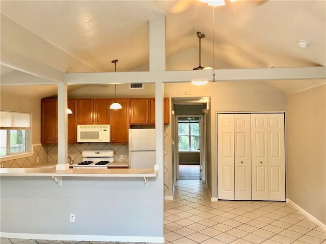 kitchen featuring pendant lighting, vaulted ceiling, decorative backsplash, white appliances, and a breakfast bar area