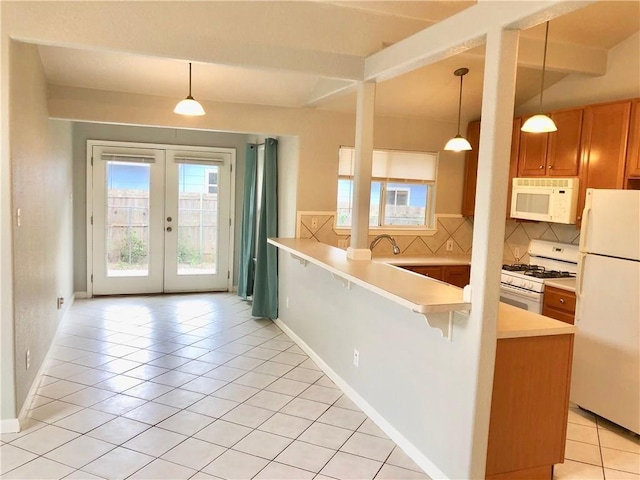 kitchen with backsplash, white appliances, kitchen peninsula, and light tile patterned floors