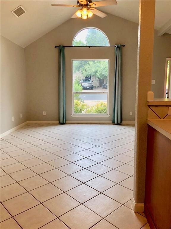 doorway to outside featuring light tile patterned flooring, vaulted ceiling, and ceiling fan