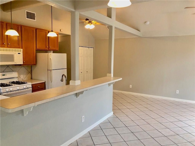 kitchen with a kitchen bar, white appliances, hanging light fixtures, and vaulted ceiling