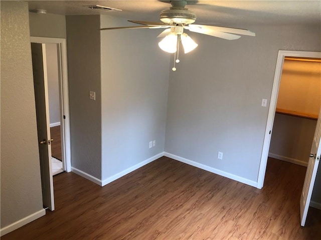 empty room with ceiling fan and wood-type flooring