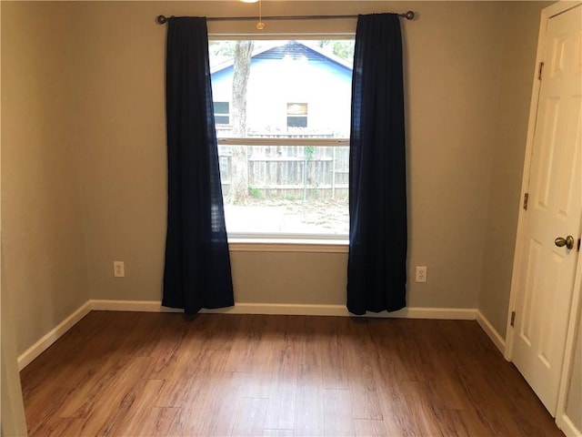 spare room with hardwood / wood-style floors