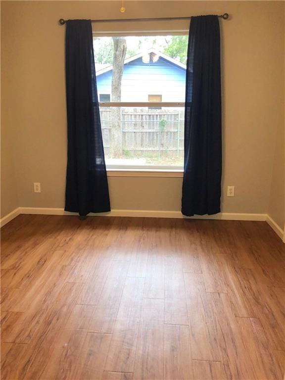 empty room with light hardwood / wood-style flooring