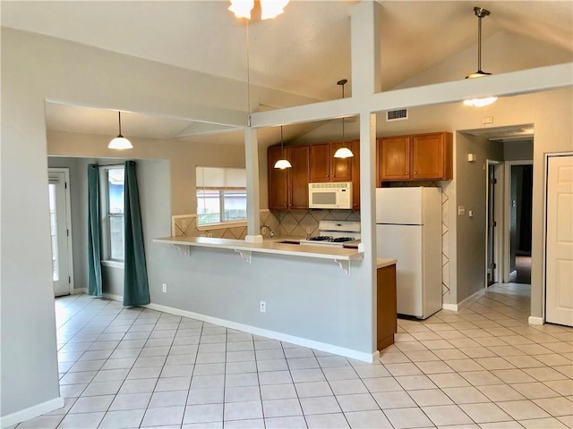 kitchen with pendant lighting, white appliances, decorative backsplash, and kitchen peninsula