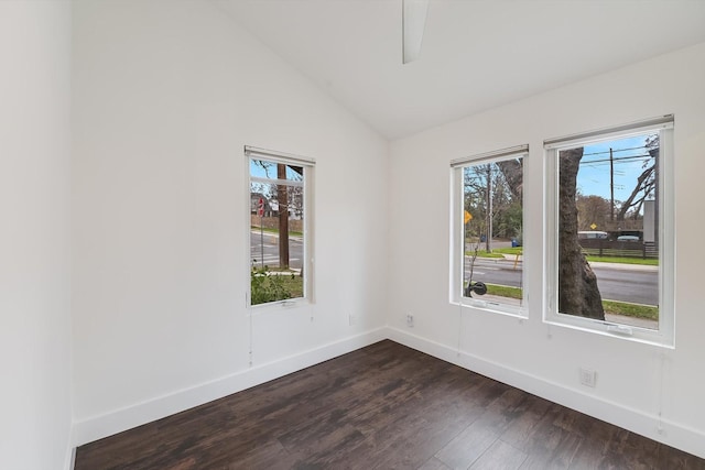 unfurnished room featuring dark hardwood / wood-style flooring and lofted ceiling