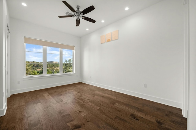 unfurnished room featuring ceiling fan and dark hardwood / wood-style floors