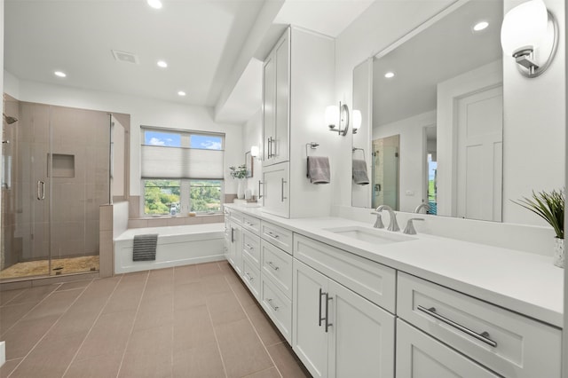 bathroom with plus walk in shower, tile patterned flooring, and vanity