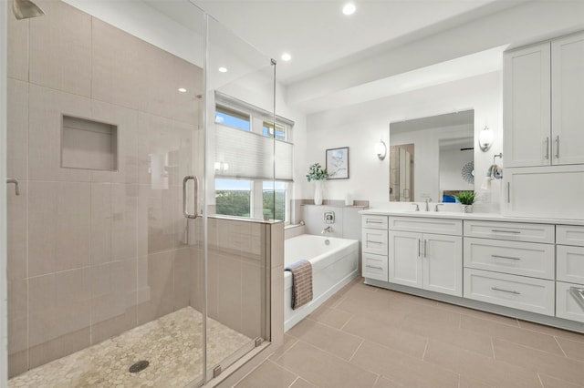 bathroom featuring independent shower and bath, tile patterned floors, and vanity