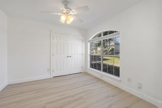 unfurnished bedroom featuring a closet, ceiling fan, and light hardwood / wood-style flooring