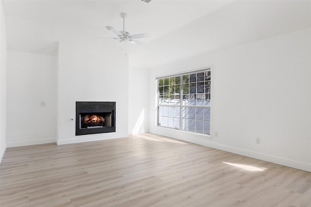 unfurnished living room with light wood-type flooring and ceiling fan