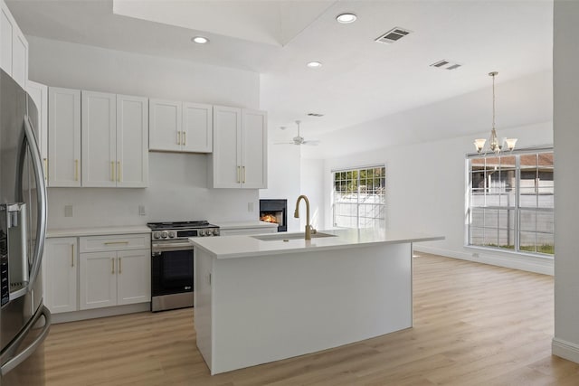 kitchen featuring sink, pendant lighting, white cabinets, and stainless steel appliances