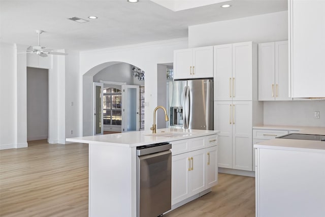 kitchen featuring white cabinets, an island with sink, sink, stainless steel fridge with ice dispenser, and ceiling fan