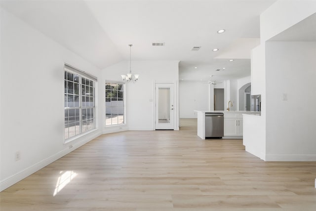 unfurnished living room featuring a notable chandelier, vaulted ceiling, and light hardwood / wood-style flooring