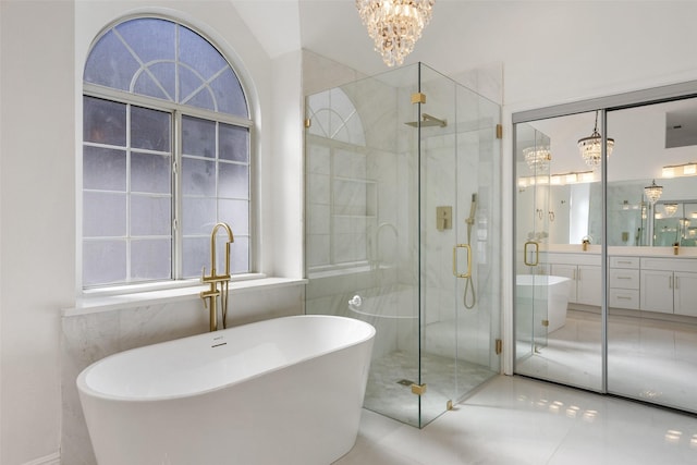 bathroom featuring vanity, tile patterned floors, an inviting chandelier, and separate shower and tub