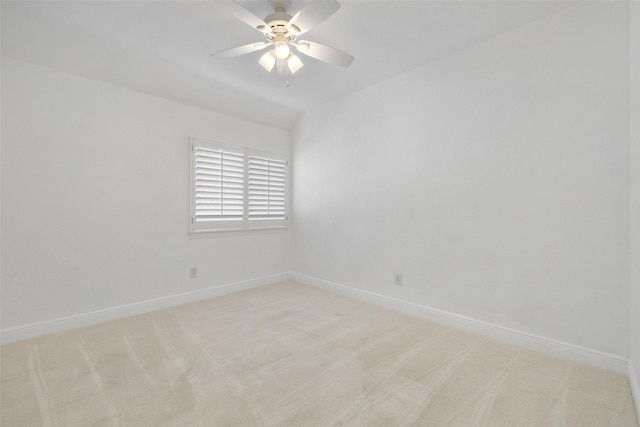 spare room with ceiling fan and light carpet