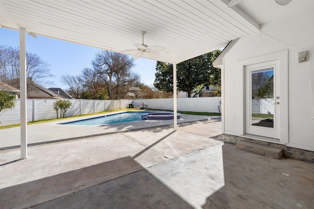 view of swimming pool with an in ground hot tub, a patio, and ceiling fan