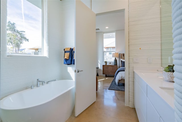 bathroom with a bath and vanity