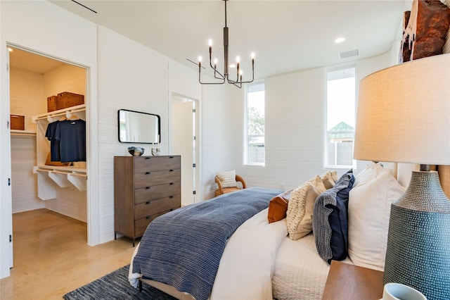 bedroom featuring a notable chandelier, a closet, and a spacious closet