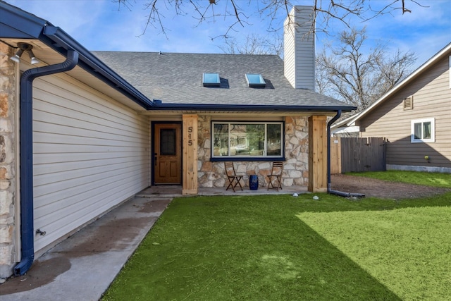 doorway to property with a lawn