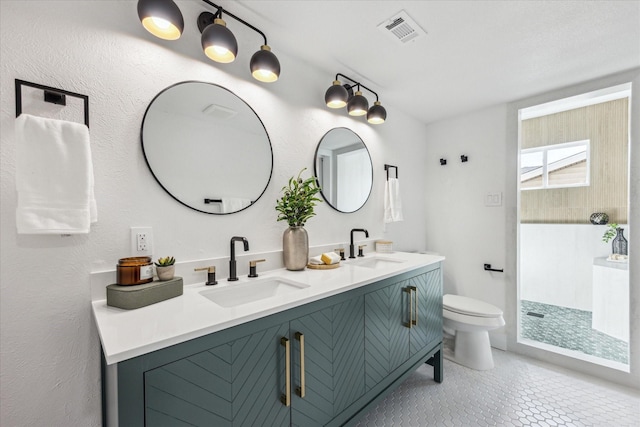 bathroom with toilet, tile patterned flooring, and vanity