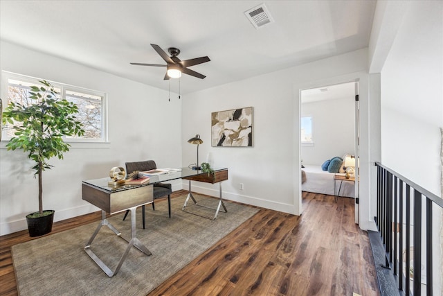 home office with ceiling fan and dark hardwood / wood-style flooring