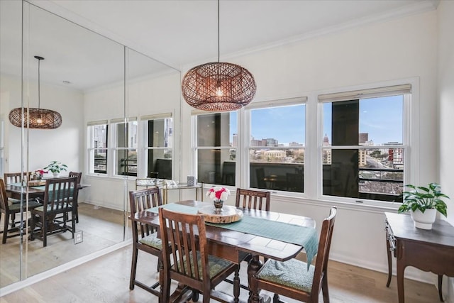 dining room featuring ornamental molding, a healthy amount of sunlight, and a city view